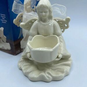 Ceramic angel tea light holder .